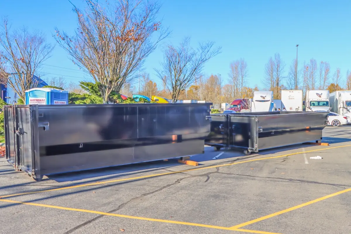 Professional dumpster rental service with roll-off container on residential driveway in Merrillville